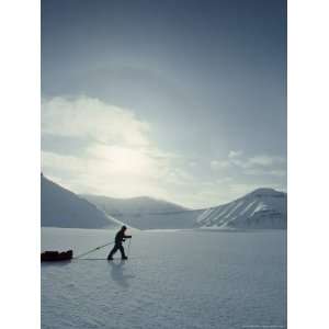  An Expedition Skier Drags a Sled Across Frozen Isfjorden 