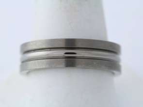 This mens ring is Titanium and it weighs 4.9 grams. It is a size 8 3 