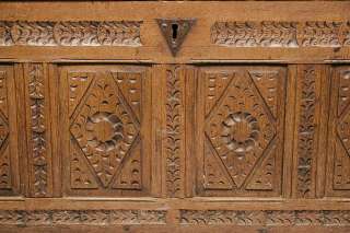 These carvings run across the front of the bottom of the bench.