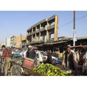  Man Selling Cucumbers from Wheel Barrow in Street Near War 