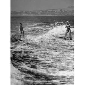  A Boy and a Girl Is Enjoying their Time Water Skiing at 